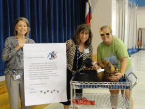 Assistant Principal Sally Gupton with Principal Elena Thrun and Coach Carrie Dasher joined school mascot, dachshund “Comet” and her sibling, to welcome students on the first day. Comet annually visits and brings a letter to the students for Principal Thrun to read.