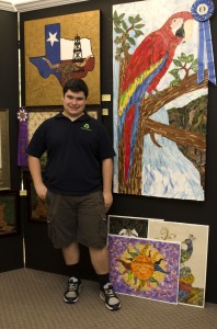 Grant stands with a few of his art pieces Photo by Sara Isola